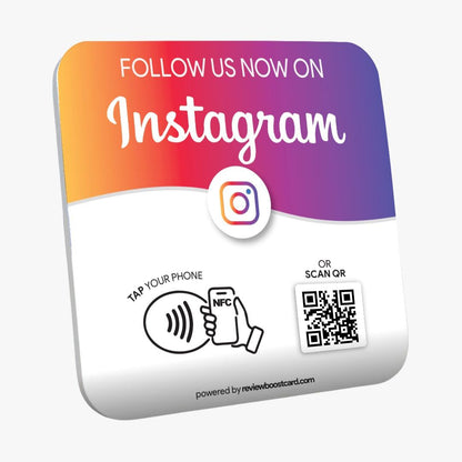 A colorful square plaque with a gradient from orange to purple, featuring the Instagram logo. It has text instructing users to "Follow Us Now on Instagram," with options to "Tap Your Phone" using NFC or "Scan QR" code, powered by reviewboostcard.com
